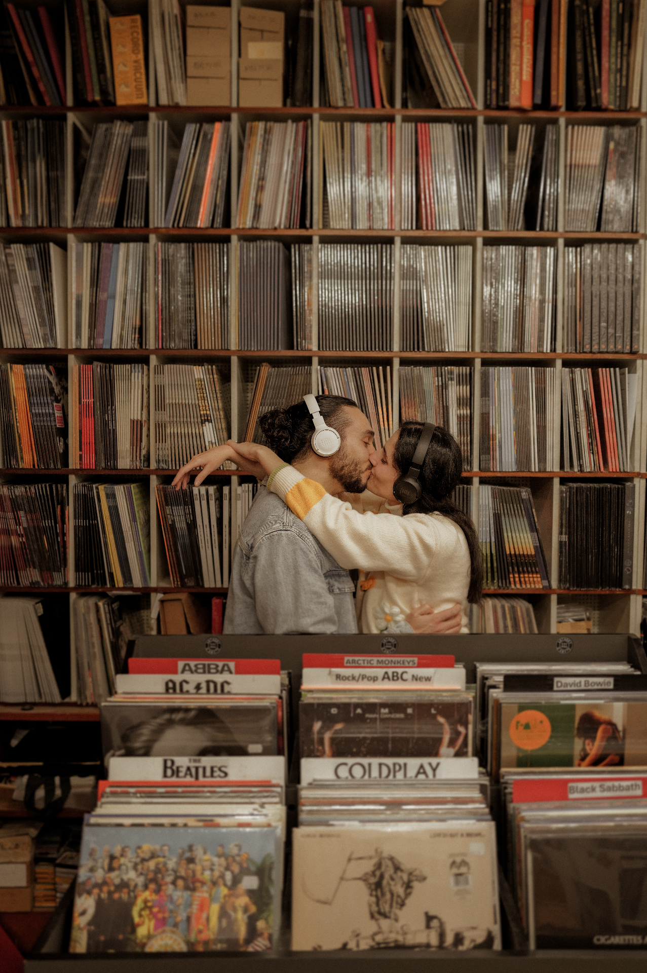 Sarah and Keith kissing in a record shop